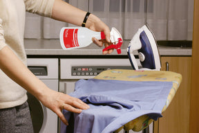 Photo of a woman using the Birchmeier Foxy Plus to spray an ironing board.